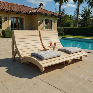 May include: A light-colored wooden double chaise lounge with two gray cushions and a small side table. The lounge is near a swimming pool and a house with a red tile roof. Two drinks are on the side table.