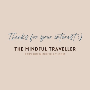 May include: Text that reads "Thanks for your interest!" in blue cursive font. Below the text is "THE MINDFUL TRAVELLER" in brown font and "EXPLOREMINDFULLY.COM" in smaller brown font.