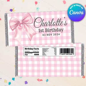May include: Pink and white checkered candy bar wrappers with a large pink bow and the text "Charlotte's 1st Birthday 03 NOV 2024". The bottom wrapper has a barcode and the words "HAPPY BIRTHDAY".