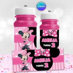 May include: Two pink bubble bottles with white caps, one labeled 4oz and the other 2oz. The bottles feature Minnie Mouse designs with polka dot bows and the text "AMELIA TURNS 2". A matching label is also shown.