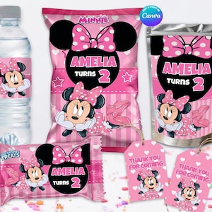 May include: Pink Minnie Mouse-themed party supplies, including water bottle labels, chip bags, treat wrappers, and favor tags. The text "AMELIA TURNS 2" is prominently displayed on several items. The tags read "THANK YOU FOR COMING".