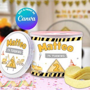 May include: A birthday-themed container and oval labels featuring the name "Matteo" and the text "IS TURNING 2". The design incorporates construction vehicles, a traffic cone, and a yellow and black hazard stripe.