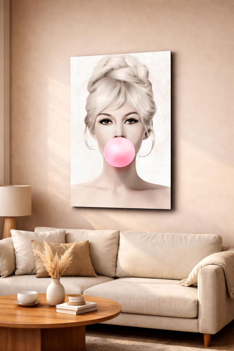 May include: A canvas print featuring a woman with blonde hair styled in an updo, blowing a large pink bubble. The artwork has a vintage aesthetic, with soft lighting and a neutral background. The woman's eyes are emphasized with dark eyeliner.