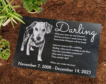 May include: Black granite pet memorial with a white etched image of a dog and a poem that reads "Darling, With your heart my soul is bound And as we dance I surely know that Some kinda of heaven will be found And you send my life a whirling Darling, when you're twirling on the floor And who cares about tomorrow? what more is tomorrow Than another day? When you swept me away" and the dates "November 7, 2008 - December 14, 2023".