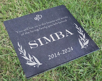May include: Black granite memorial stone with the inscription "You still live on in the hearts and minds, of the loving family you left behind" and the name "SIMBA" with the dates "2014-2024".