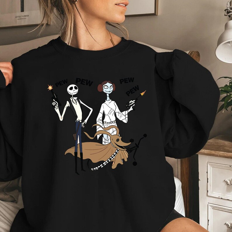 May include: Black sweatshirt with a graphic print of Jack Skellington and Sally from The Nightmare Before Christmas dressed as Han Solo and Princess Leia from Star Wars. The text "PEW" is repeated multiple times around the characters.