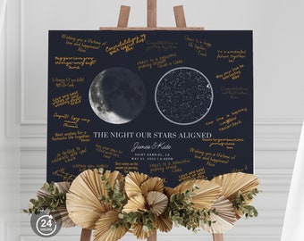 May include: A dark blue wedding sign on an easel, featuring a moon phase and a star map. The sign includes the names James & Kate, the date May 21, 2022, and well wishes. Dried floral arrangement at the bottom. Text: "The Night Our Stars Aligned."