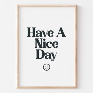 May include: A framed print with the text "Have A Nice Day" in black text on a white background. A smiley face is below the text.