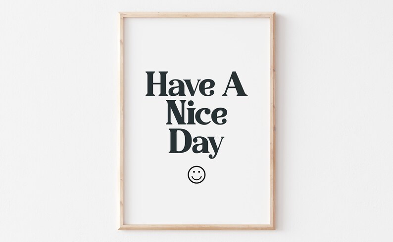 May include: A framed print with the text "Have A Nice Day" in black text on a white background. A smiley face is below the text.