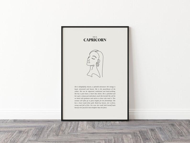 May include: Black and white line art print of a woman's face with the text "Capricorn" and a description of the astrological sign. The print is framed in a black frame.