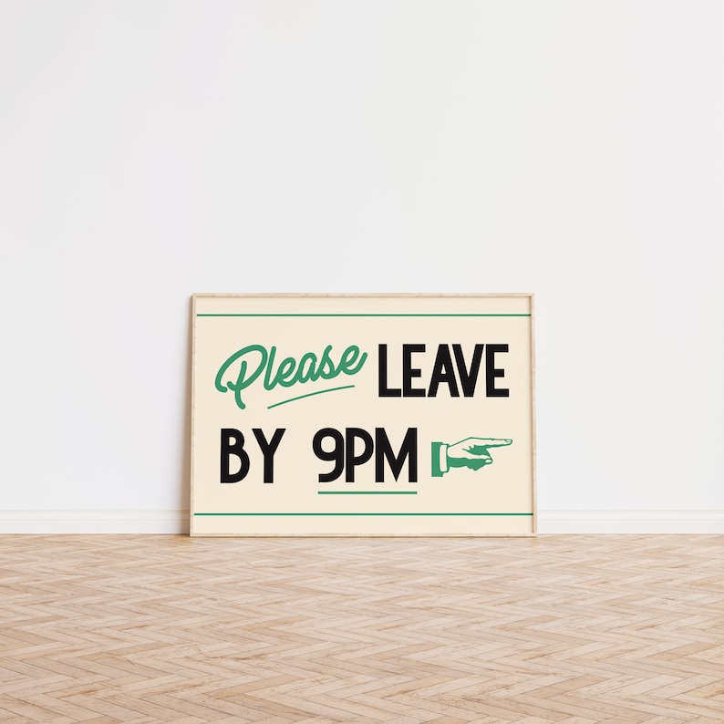 May include: A framed sign with the words "Please Leave By 9PM" in a retro font. The text is in black and green on a cream background, with a pointing hand graphic. The frame is a light wood color.