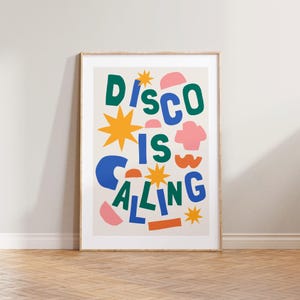 May include: A colorful poster with the text "Disco is Calling" in a playful, cut-out style. The text is in blue, green, and yellow, with various shapes and stars in pink, orange, and red.