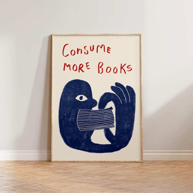 May include: A blue illustration of a person with a book covering their mouth. The text "CONSUME MORE BOOKS" is written in red above the person.
