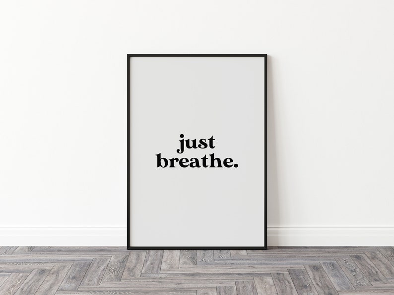May include: Black framed poster with white background and the text "just breathe." in black bold font.