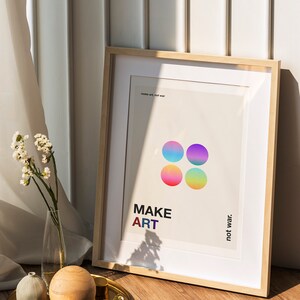 Pode incluir: Um p&ocirc;ster emoldurado com fundo branco e c&iacute;rculos coloridos. O p&ocirc;ster diz "MAKE ART not war."