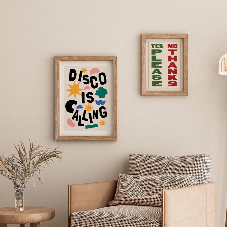 May include: Two framed prints with colorful abstract designs. The print on the left says "Disco is Calling" in black letters with colorful shapes and stars. The print on the right says "Yes Please" in green letters and "No Thanks" in red letters.