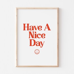 May include: A framed print with the text "Have A Nice Day" in red letters and a red smiley face below the text.