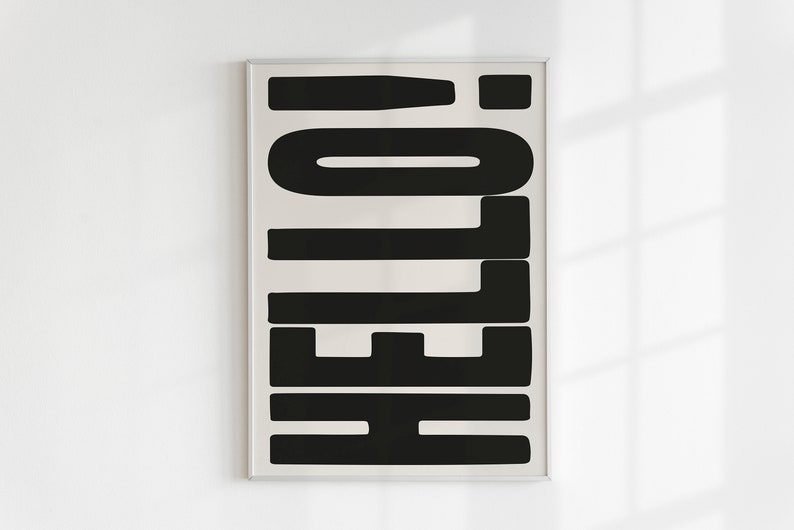 May include: A framed print with the word "HELLO" in black letters on a white background.