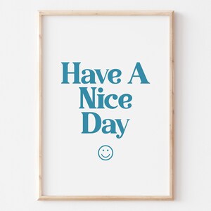 May include: A framed print with the text "Have A Nice Day" in blue lettering and a smiley face below the text.