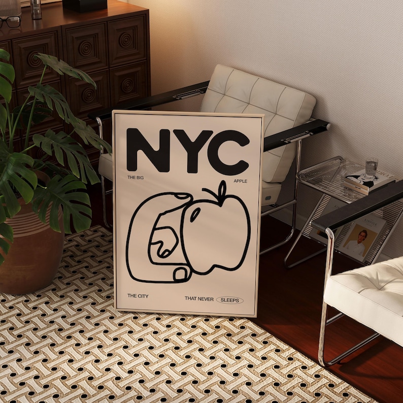 May include: A black and white poster with the text "NYC" in large bold letters. The poster also includes the text "The Big Apple, The City That Never Sleeps" and a graphic of a hand holding an apple.