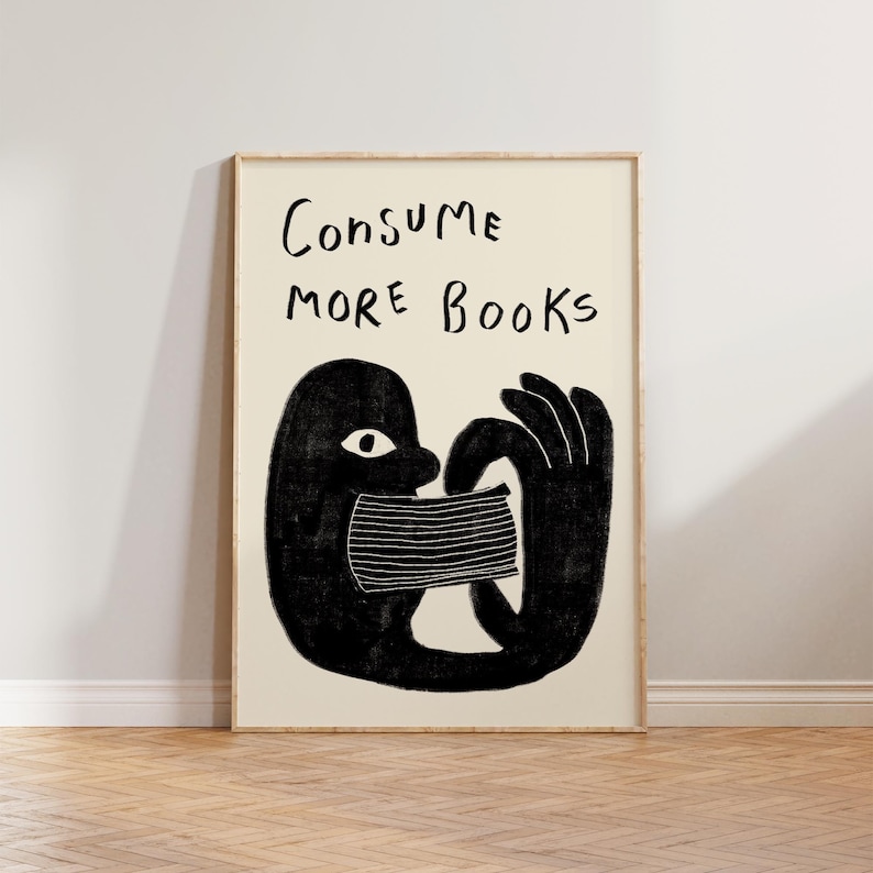 May include: Black and white illustration of a person consuming books. The text "CONSUME MORE BOOKS" is written above the person.