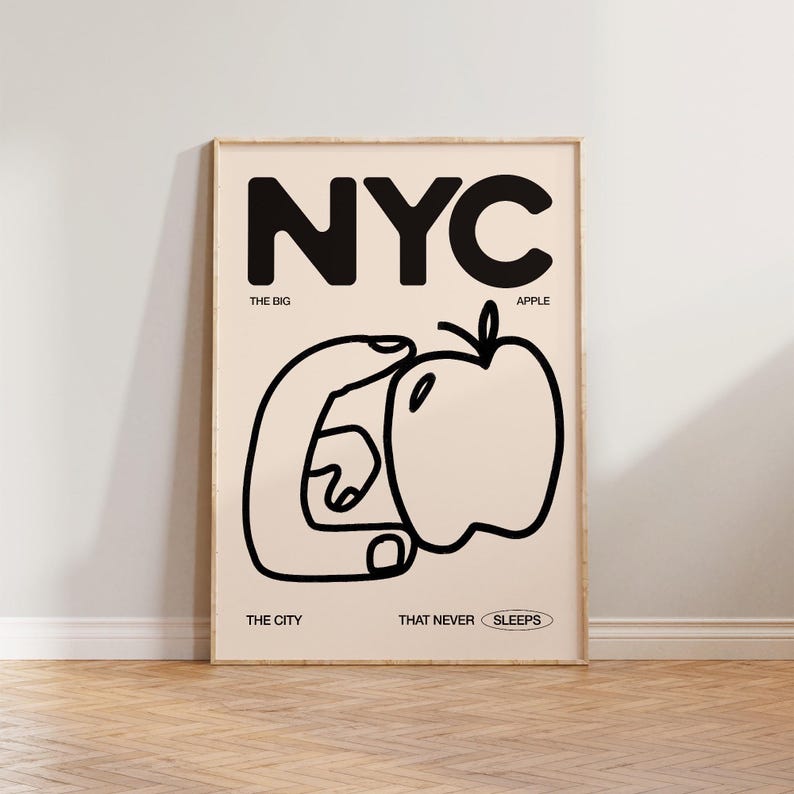 May include: Black and white graphic poster with the text "NYC" in large bold letters. The poster features a hand holding an apple with the text "The Big Apple" below the NYC text. The text "The City That Never Sleeps" is at the bottom of the poster.