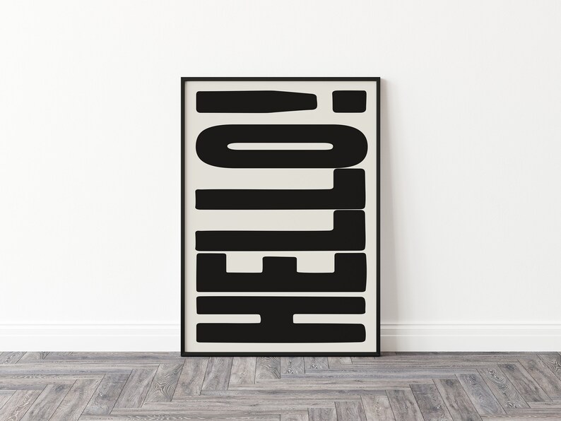 May include: Black and white abstract art print with the word "HELLO" in bold, block letters. The print is framed in a black frame.