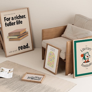 May include: A living room interior with a beige armchair, a rug, and a side table with a magazine on top. There are four framed posters on the wall and on the floor. One poster says "For a richer, fuller life, wake up and read." Another poster says "Flower Market." The third poster says "The Literary Institute 1944." The fourth poster says "You must be the place".