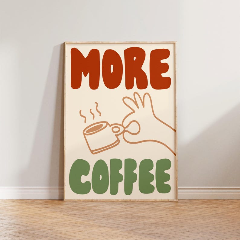 May include: A beige poster with the text "MORE COFFEE" in red and green letters. A cartoon hand holds a steaming cup of coffee.
