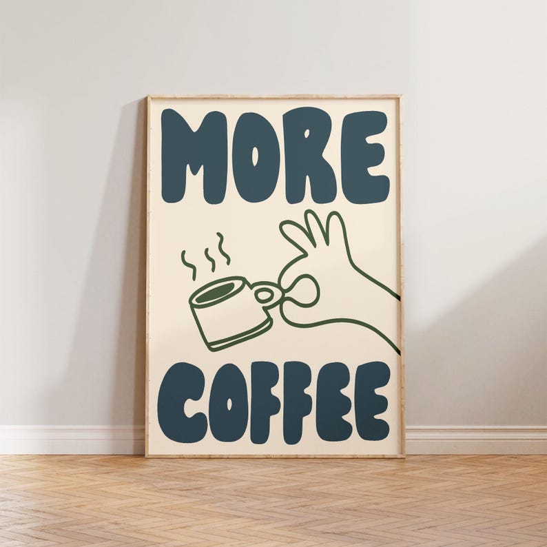 May include: A beige poster with the text "MORE COFFEE" in blue and green lettering. A green hand is holding a blue coffee cup with steam coming from it.