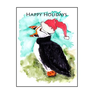 May include: Watercolor illustration of a puffin wearing a Santa hat, with the text "HAPPY HOLIDAYS" above. The bird has black, white, orange, and red coloring, set against a teal and green watercolor background.