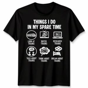 May include: Black t-shirt with white text and graphics. The text reads "THINGS I DO IN MY SPARE TIME" with illustrations of trains, a TV, a laptop, people, gears, and a bed. The shirt is a crew neck.