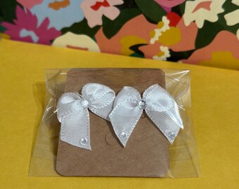 mini bedazzled white bow earrings