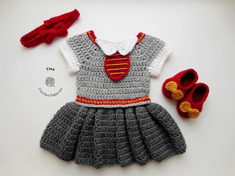 May include: A gray crocheted dress with red and gold accents, a red headband, and red shoes with gold bows. The dress has a white collar and a red and gold stripe design on the bodice. "Tina Crochet Patterns" is written on the bottom left corner of the image.