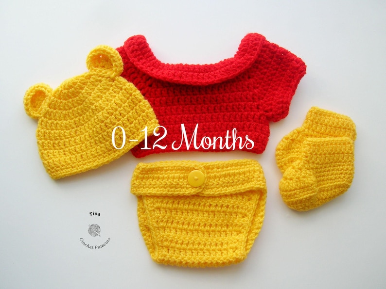 May include: A crocheted baby outfit in red and yellow. The outfit includes a hat, a shirt, a diaper cover, and booties. The outfit is sized for 0-12 months.