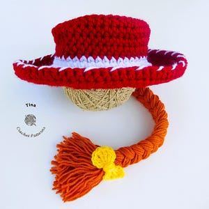 May include: A handmade crochet hat in red with a white trim, a braided orange yarn, and a yellow accent. The hat is designed to resemble a cowboy hat. The image includes the text "Tina Crochet Patterns".