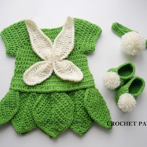May include: Crochet pattern for a green and white fairy costume for a baby. The costume includes a dress, headband, and shoes.