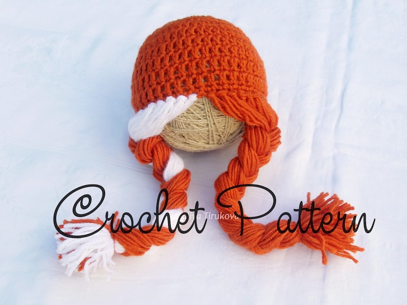 May include: Orange and white crocheted hat with two long braids. The hat is on a beige ball of yarn. The text "Crochet Pattern" is visible in the image.