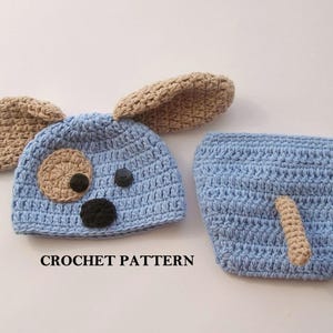 May include: Crochet pattern for a baby dog costume. The hat is blue with brown ears and a brown nose. The diaper cover is blue with a brown tail.