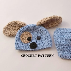May include: Crochet pattern for a baby hat and booties set. The hat is blue with brown ears and a dog face. The booties are blue.