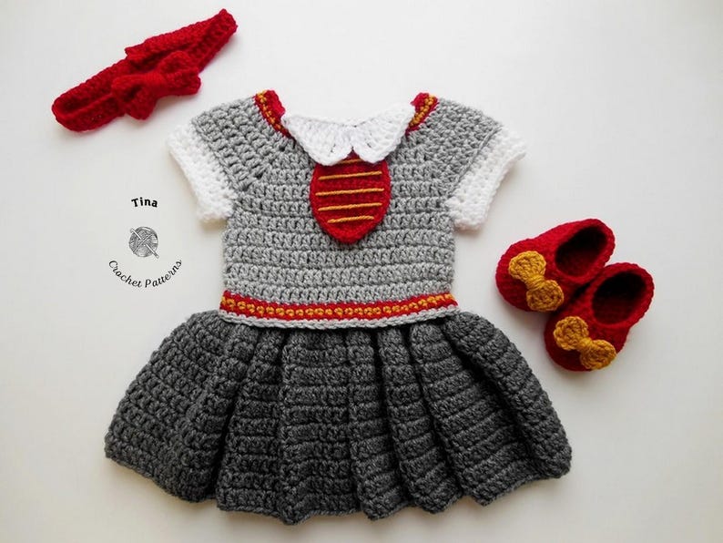 May include: A gray crocheted dress with a red and gold trim, a white crocheted collar, and a red and gold crocheted tie. The dress is paired with a red crocheted headband and red crocheted shoes with gold bows.