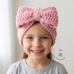 May include: A light pink crocheted bow headband. The headband is made of a chunky yarn and features a large bow on top. The image also includes the text "Tina Crochet Patterns".