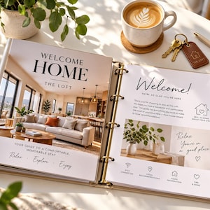May include: An open three-ring binder featuring a welcome guide for a rental property titled Welcome Home The Loft. The pages include interior photos of a living room, text, and icons for house information, local recommendations, and checkout.