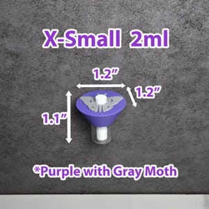 May include: A purple funnel with a gray moth design, measuring 3 cm wide and 2.8 cm tall. The text "X-Small 2ml" and "*Purple with Gray Moth" are displayed. The funnel is on a gray background.