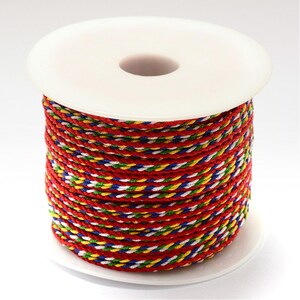 May include: A spool of red, white, blue, green and yellow braided cord.