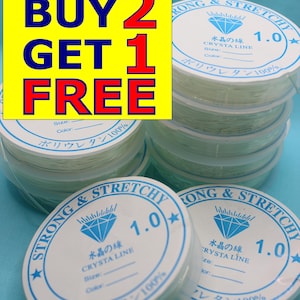 May include: Several spools of clear, stretchy crystal line, with labels reading "Strong & Stretchy" and "Crystal Line 1.0". A yellow and blue promotional graphic displays "Buy 2 Get 1 Free".