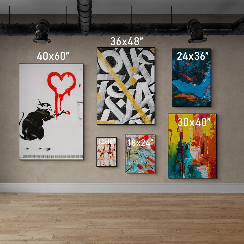 May include: A gallery wall featuring nine framed art prints in various sizes and styles. The prints include abstract art, graffiti, and a black and white rat with a red heart. The prints are arranged in a grid pattern on a beige wall.