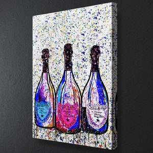 May include: Three champagne bottles with colorful paint splatters on a white background. The bottles are labeled "Veuve Clicquot" with different vintage years. The bottles are in a row, with the middle bottle having a pink label and the other two bottles having blue labels.