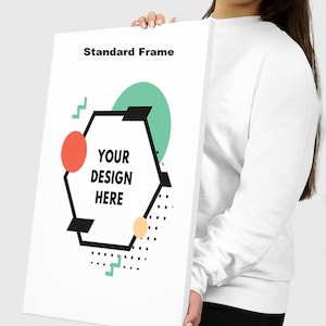 May include: A white canvas with a geometric design featuring a hexagon with the text "YOUR DESIGN HERE" inside. The hexagon is surrounded by a green circle, a red circle, and a yellow circle with black polka dots. The text "Standard Frame" is at the top of the canvas.