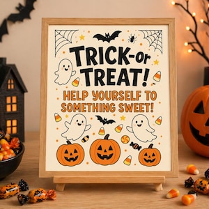 Peut inclure: Une affiche encadrée d'Halloween avec les mots "Trick-or-Treat!" et "Help Yourself to Something Sweet!" présente des fantômes de dessins animés, des citrouilles, des chauves-souris et des bonbons. L'affiche est exposée sur un chevalet en bois, entourée de décorations d'Halloween.